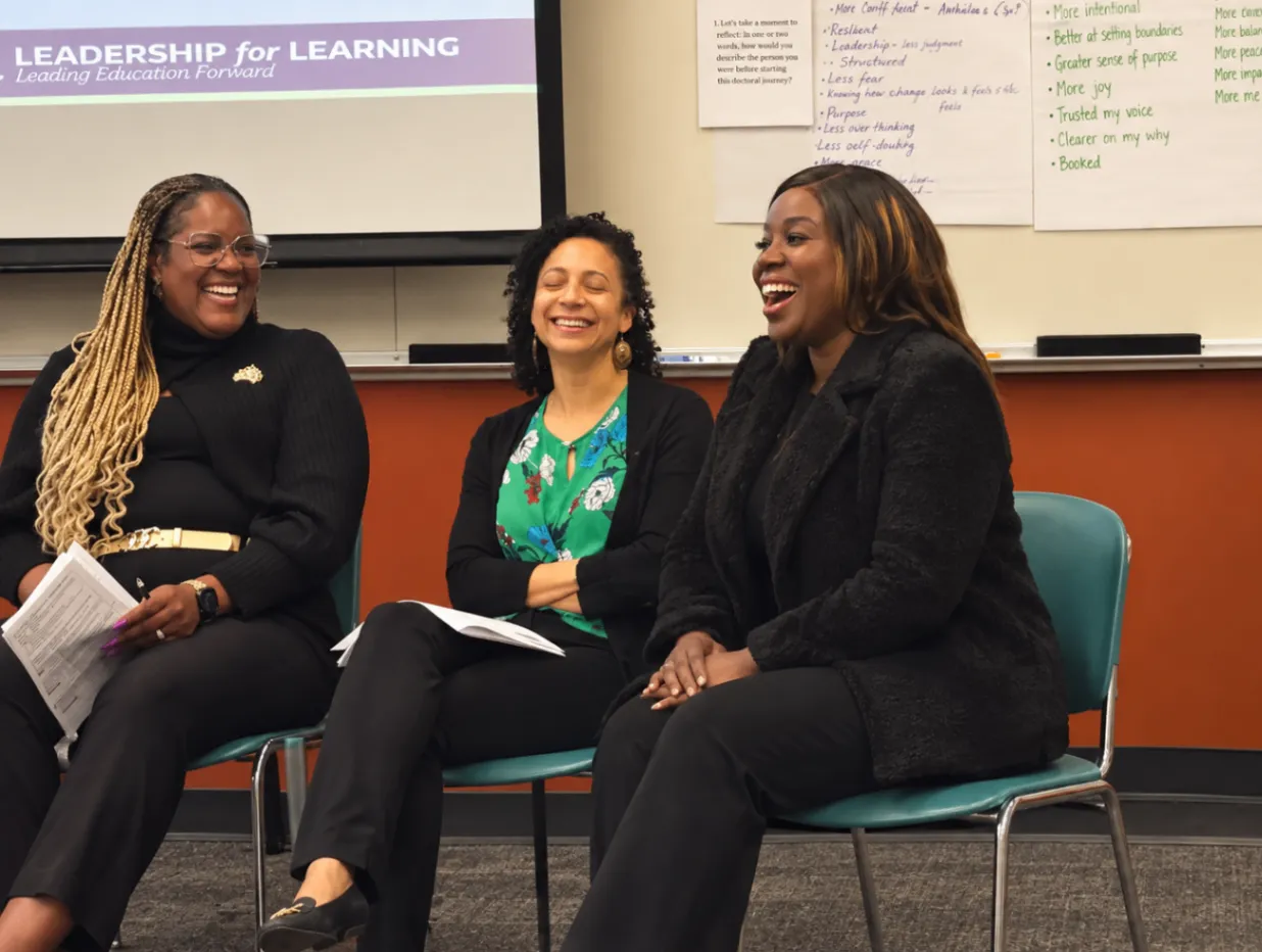 Three women collaborating in a learning session